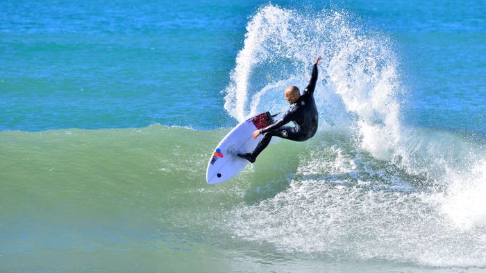 A surfer executes a thrilling maneuver on the waves in Oceanside, CA.
