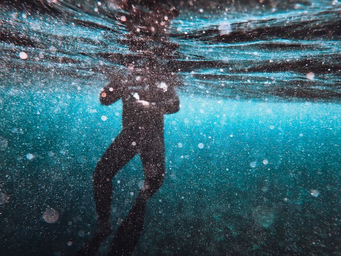 Silhouette of a diver surrounded by bubbles underwater at Farasan Island, Saudi Arabia.