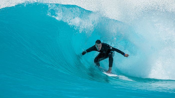 Surfer expertly riding a powerful wave at Tullamarine, VIC, Australia.