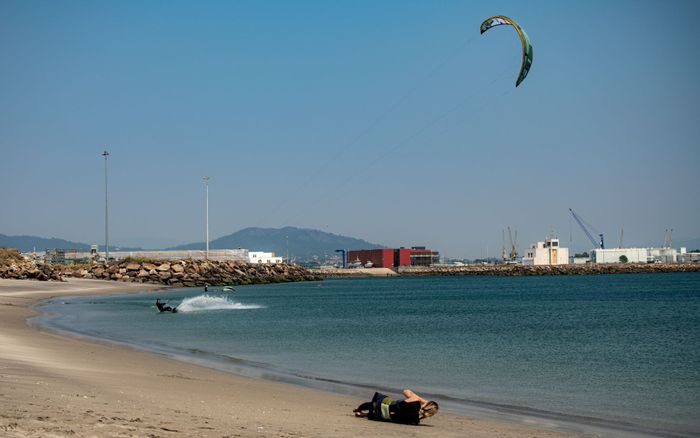 Dynamic kitesurfing scene at Viana do Castelo beach, Portugal, highlighting adventure and tranquility.