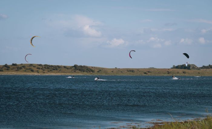Exciting kitesurfing scene on Denmark's Ebberup coast, perfect for summer water sports enthusiasts.