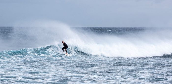 Thrilling image of a surfer riding powerful ocean waves, showcasing adventure and skill.