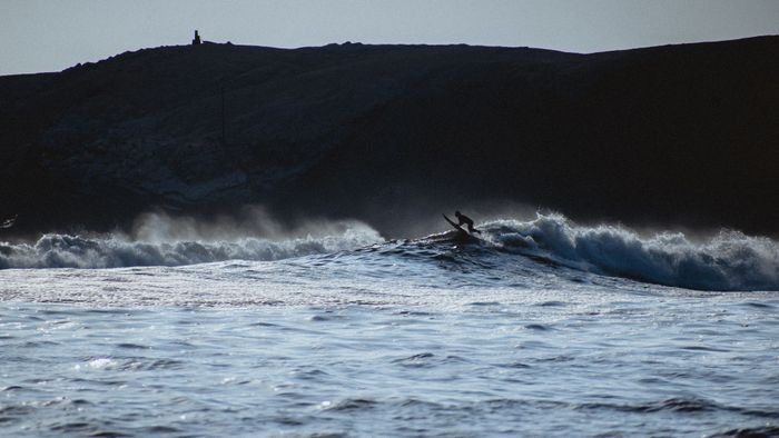 A lone surfer conquering waves at Punta Hermosa, Lima Province, Peru.