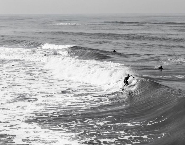 Surfer skillfully navigating a wave at Mongaguá beach, Brazil.