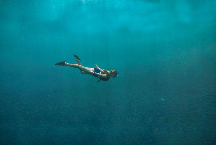 Diver explores the turquoise waters of Moalboal, Cebu, Philippines. Ideal for adventure and travel themes.