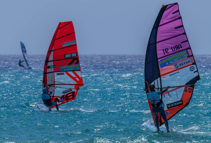 Windsurfers compete on the vibrant waters of Fuerteventura, capturing the thrill of the sport.