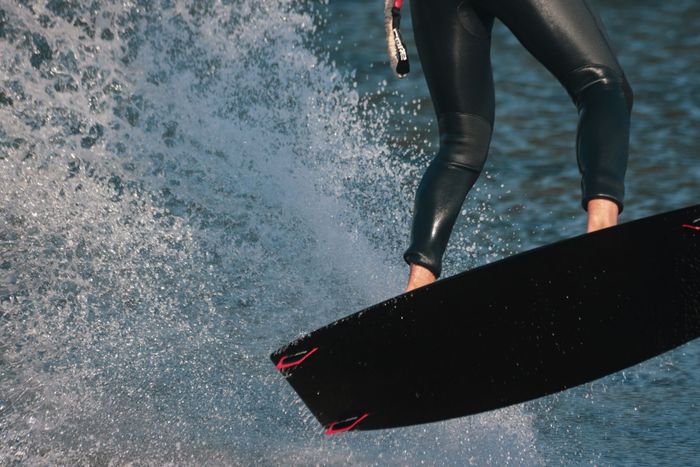 Close-up of a kitesurfer in action on the Danish coast showcasing dynamic movement and water splashes.