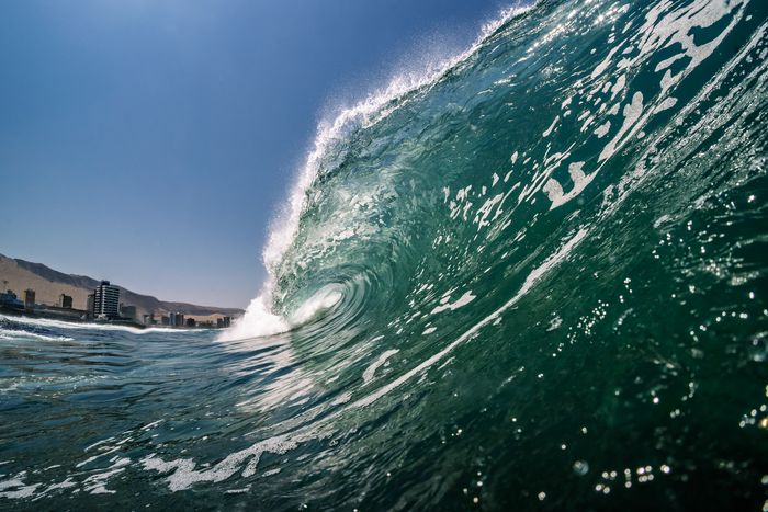 A powerful wave crest captured at Iquique, Chile's Pacific Ocean coast, showcasing its natural beauty.