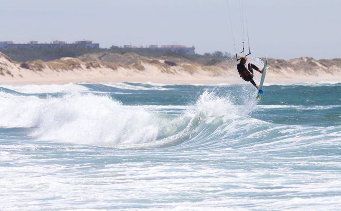 Dynamic kitesurfing action captured against the stunning backdrop of Viana do Castelo, Portugal.