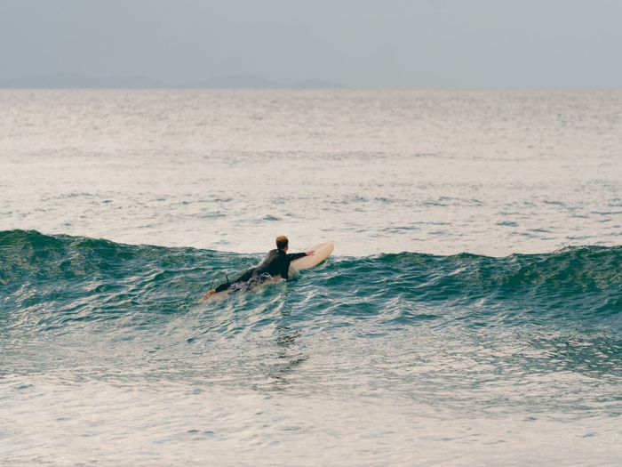 An adventurous surfer captures the thrill of surfing at Byron Bay, New South Wales, Australia.