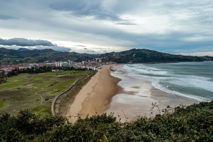 Scenic aerial view of Zarautz Beach with coastline and mountains in the Basque Country, Spain.