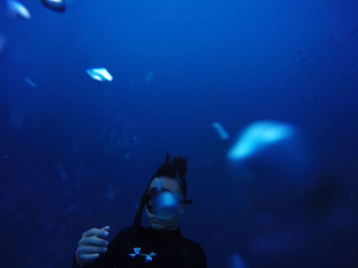 Underwater photo of a diver exploring the deep blue ocean, surrounded by vast water.
