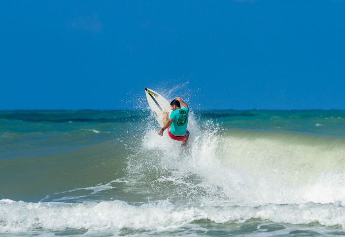 Dynamic shot of a surfer catching waves at Tibau do Sul, Brazil.