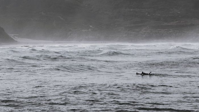 Surfers ride the dynamic waves of Ericeira Beach in Portugal, showcasing adventure in nature.