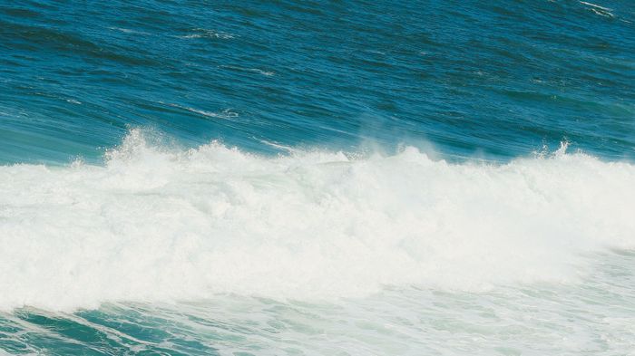 Dynamic ocean waves crashing on the beach in Rio de Janeiro, Brazil. Perfect for summer themes.
