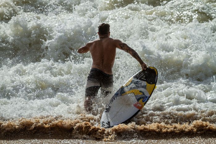 A dynamic shot of a surfer riding waves at Baía Formosa beach captures the exhilaration and action of the sport.