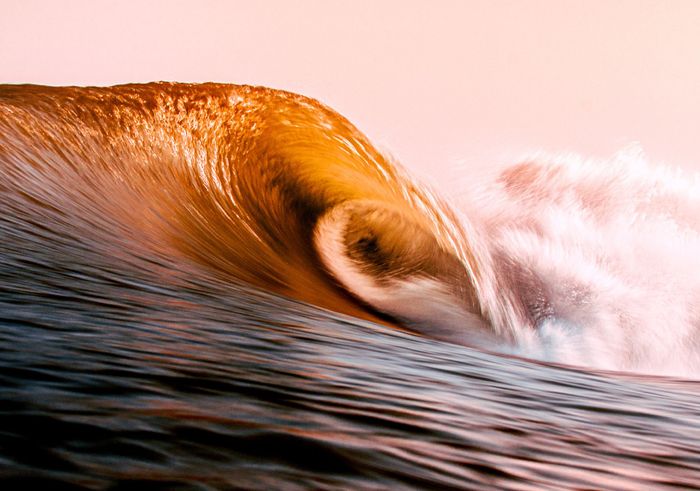 Vibrant golden ocean wave captured at sunset in Miyazaki, Japan, showcasing natural beauty.