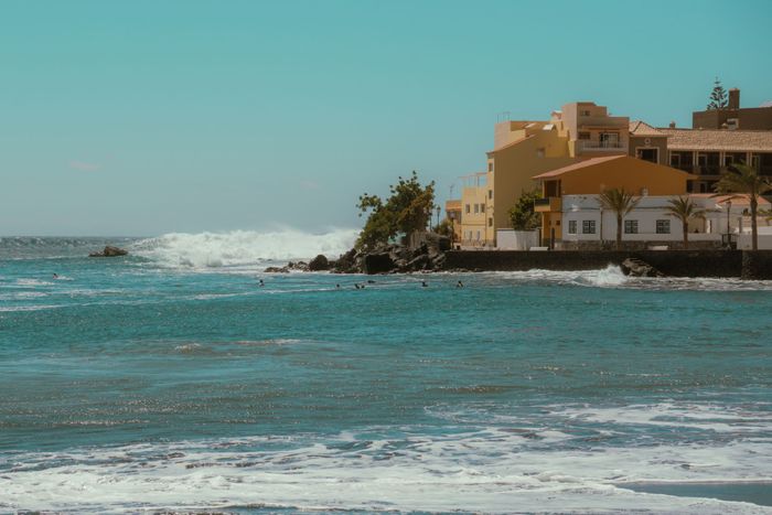 Charming oceanfront view of Valle Gran Rey in the Canary Islands, Spain, with turquoise water and retro tones.