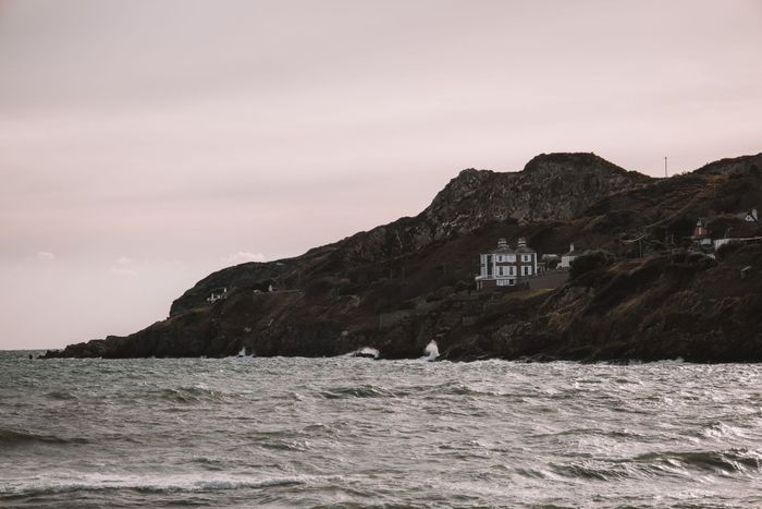 A picturesque view of Howth Head's rugged coast in Dublin, Ireland, with a serene ocean backdrop.