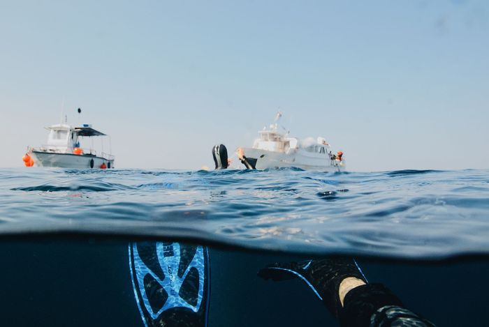 Experience the thrill of scuba diving near yachts in the open ocean. Ideal for adventure seekers.
